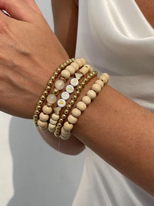 Detail of layered bohemian bracelets with wooden beads and MAMA letter beads