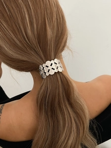 Silver metal hair clip with hollow diamond patterns and wavy edges for ponytails