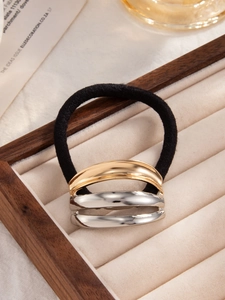 Detail of high-elastic ponytail holder with gold and silver geometric metal accent