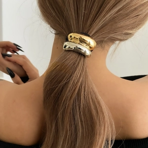 Sleek metallic ponytail cuff hair tie in gold and silver with minimalist geometric design