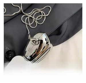 Detail of silver metallic butterfly bag featuring high-quality hook and bead chain strap
