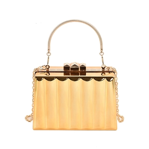 Elegant gold metal clutch bag with wavy texture, metal handle and chain shoulder strap