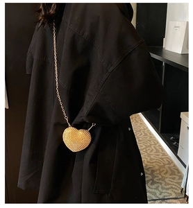 Sparkling gold heart shaped clutch bag with rhinestone tassels and thin chain strap