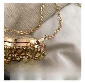 Detail shot of the golden hook and luxury rhinestone fringe on the mini evening bag