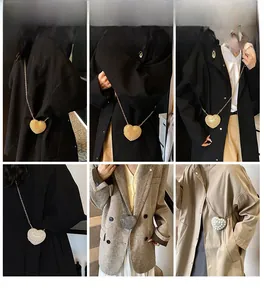 Three heart-shaped mini bags shown on models with chains, pearls and glitter finishes