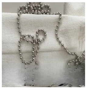 Detail of silver beaded chain strap with pearl and rhinestone hook for evening bags