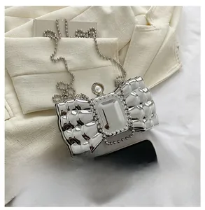 Silver bow evening clutch with sparkling crystals and pearl clasp for size reference