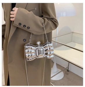 Silver bow evening bag with gemstone inlay and pearl clasp shown with beaded chain