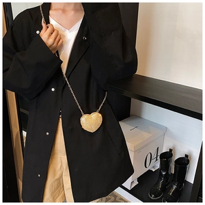 Detailed view of a golden heart-shaped rhinestone mini bag with a fine chain strap