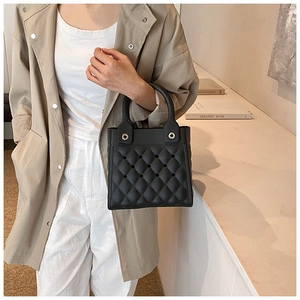 Detailaufnahme der schwarzen EVA-Tasche mit Rautensteppmuster und perforiertem Design