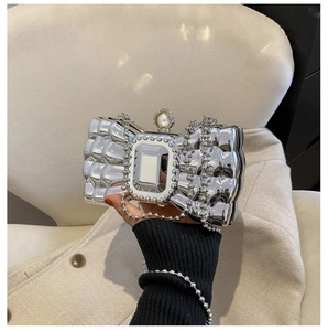 Detail of silver metallic butterfly evening clutch with pearl clasp and chain strap