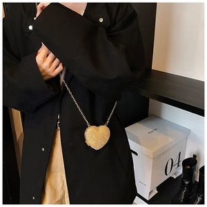 Golden heart-shaped crossbody bag with glitter rhinestones and a metal chain strap