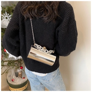 Detail of silver metallic cylinder bag with chunky rhinestone chain and pearl buckle