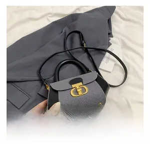 Close-up of a vintage canvas crossbody bag with a prominent gold CD metal buckle