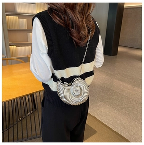 Detailed back view of a silver nautilus shell evening bag with metal chain strap