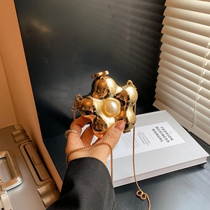 Golden flower acrylic clutch bag with pearl detail and elegant metal chain strap