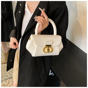 Detail of white leather shoulder bag with gold metal CD buckle and lychee texture