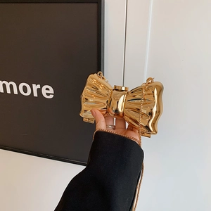 Golden butterfly-shaped evening clutch bag with metallic pleated texture and chain strap