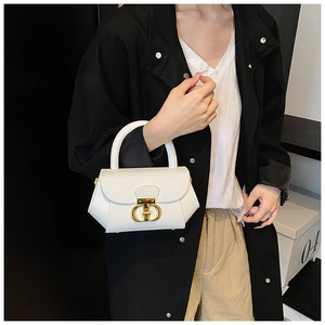 Detail of white leather trapezoid bag with iconic gold D-shaped interlocking metal buckle