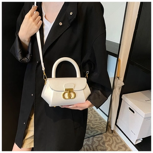 Close-up of white lychee pattern leather handbag with elegant golden T-shaped metal lock