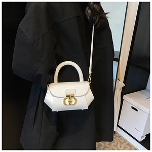 White leather mini tote bag with gold metal CD logo shown on a black winter coat