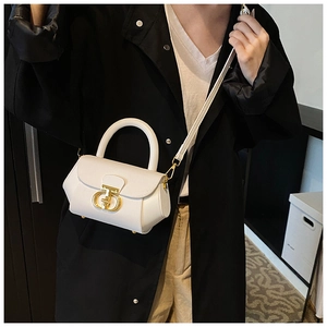 Detail of white lychee leather mini bag with gold CD-style buckle on a model