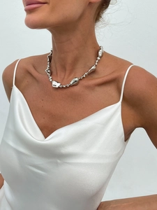 Silver liquid metal pearl necklace worn by a model in elegant white satin clothing