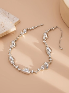 Detailed view of irregular silver-plated lava beads and lobster clasp on necklace