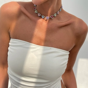 Collier en cristal coeur coloré avec base argentée porté avec ombre de soleil naturelle