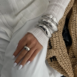 Silver chunky metal bracelet set with floral texture and smooth minimalist bangle