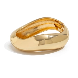 Polished gold irregular wavy bangle featuring a glossy surface and spring hinge clasp