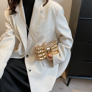Golden butterfly bow evening clutch bag with pearl detail and metallic chain strap