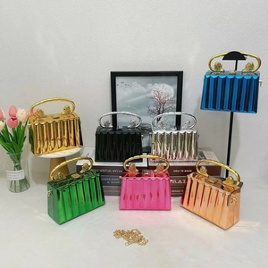 Acrylic box clutch with ice-crack texture, lion head handle, and gold crossbody chain strap