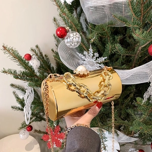 Golden cylindrical patent leather bucket bag with pearl clasp and festive chain strap