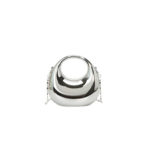 Sleek silver metallic crescent handbag with circular handle and chain strap for evening