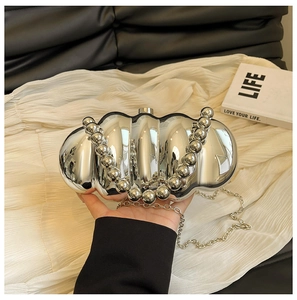 Silver wavy acrylic evening bag with beaded handle and metallic chain strap detail
