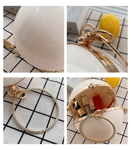 Detailed views of white sphere pearl evening bag with rhinestone handle and chain strap