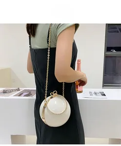Chic white spherical hard shell clutch bag with gold chain and rhinestone ring handle