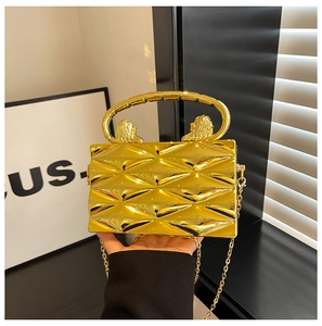 Golden box clutch featuring lion head metal handles and textured geometric pattern