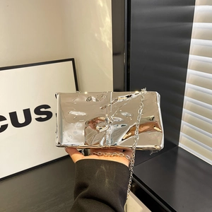 Silver liquid metal quilted chain bag with futuristic texture and high-gloss finish