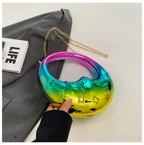 Detailed close-up of rainbow moon handbag with star relief and gold chain strap