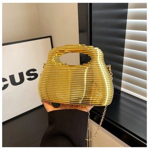 Detailed view of luxury gold hollow metal cage evening clutch bag with snake chain