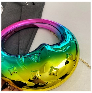 Detail of crescent evening bag with rainbow gradient finish and gold chain strap