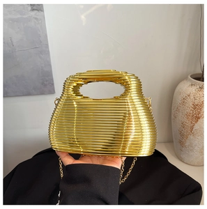 Detailed view of the gold metallic textured evening bag with horizontal stripe pattern