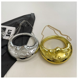 Detailed macro of gold and silver moon-embossed hard shell chain evening bags