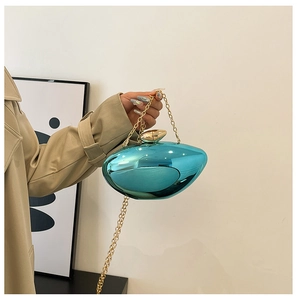 Detail of blue metallic mirror evening bag with gold chain and irregular oval shape