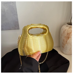 Detail view of gold metallic layered handbag with sleek chain strap and mirrored finish