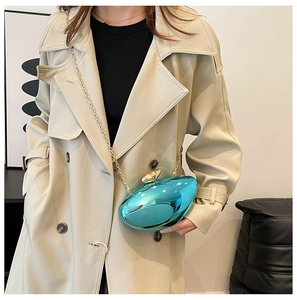 Detail of teal metallic mirror clutch with gold pebble clasp and fine chain strap