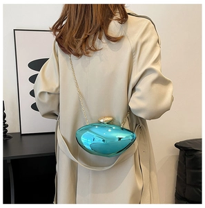 Detailed view of teal mirror surface shoulder bag with elegant gold chain and hardware