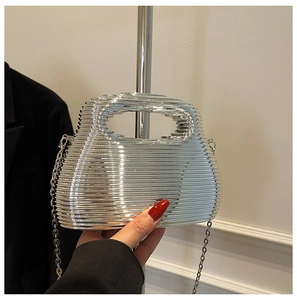 Close-up of a silver ripple texture evening handbag with metallic chain strap detail